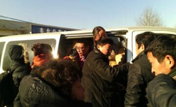 A dozen petitioners facing repatriation exit a van outside a government complex in Beijing, Dec. 9, 2013. Photo courtesy of petitioners