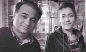 Ilham Tohti and his wife in a photo sent to RFA's Uyghur Service via WeChat on Jan 13, 2014, two days before his detention. Photo: RFA